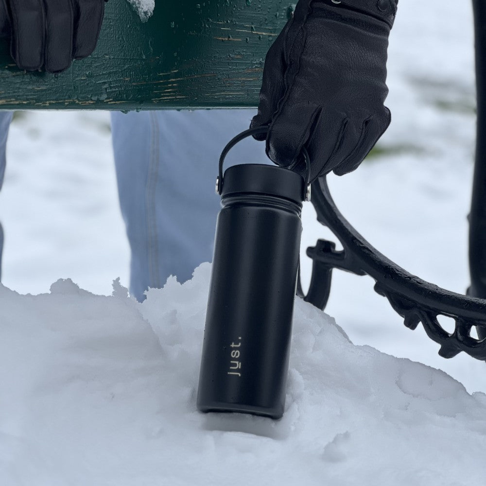 Black water bottle in the snow