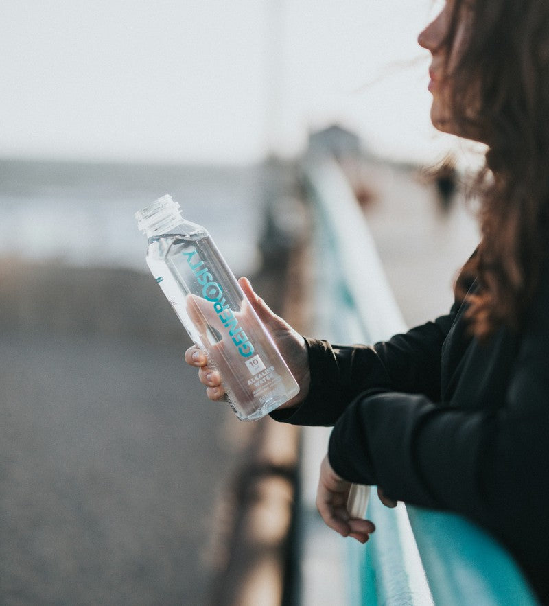 someone holding a plastic custom water bottle